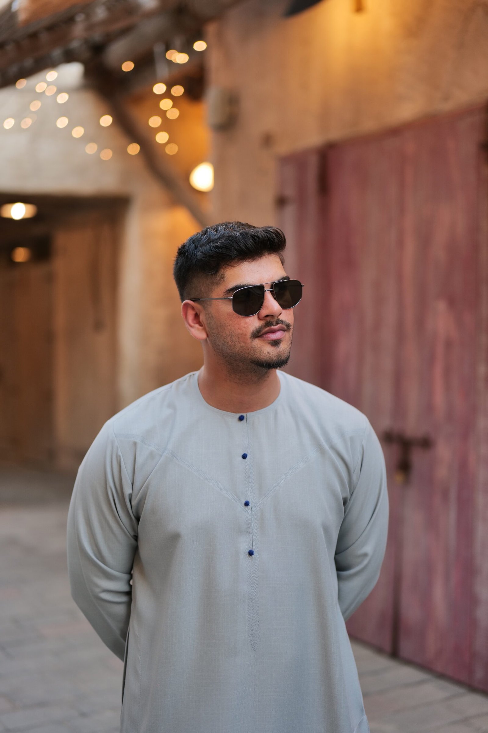 Grey thobe with blue button half view